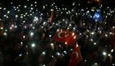 Привържениците на турския премиер Реджеп Ердоган светят с мобилните си телефони и празнуват изборната победа пред партийния щаб в Анкара.