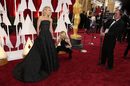 Американската актриса и водеща Кели Рипа също бе част от звездите на червения килим. Тя бе облечена в черна рокля на Кристиан Сириано, комбинирана с бижута на "Фред Лейтон". <br> 
На снимката: Асистенка оправя роклята на Кели Рипа.