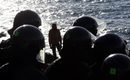 Полиция охранява протест на мигранти на плаж на границата между Италия и Франция.