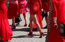 Участници в шествието "Дами в червено" отбелязват Деня на лятното слънцестоене с разходка по алея край река Енисей в Красноярск, Русия.