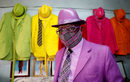 Кенийския модист Джеймс Майна Муванги позира за снимка демострирайки колекцията си от 160 костюма с подходящи аксесоари, включително маска за лице в резиденцията му в Найроби, Кения.