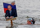 Член на местен клуб по зимно плуване участва в събитие по случай 69-ия рожден ден на руския президент Владимир Путин във водите на река Об в Барнаул, Русия