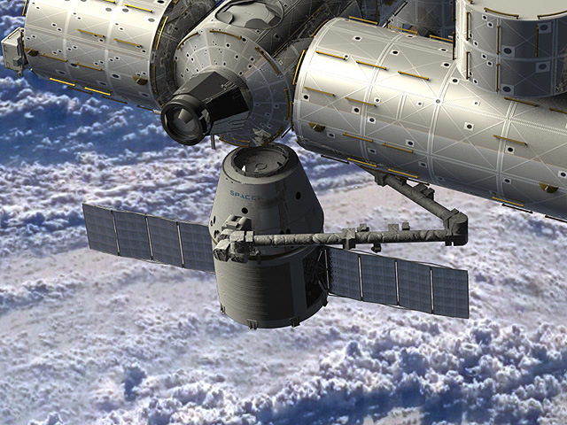 Художествено изображение на космическия кораб "Dragon" в момента на скачване към модула "Хармония" на МКС.